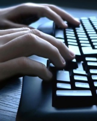 Person typing on computer keyboard